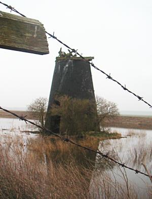 Ruined windmill, with barbed wire 